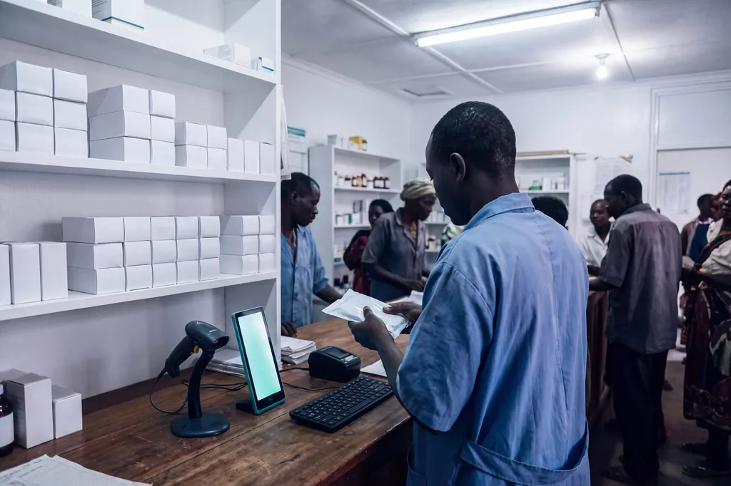 The same pharmacist with a scanner and a tablet.